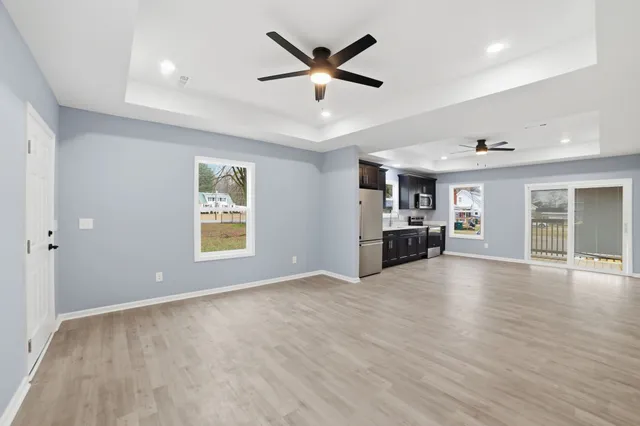 a view of an empty room with window and cabinet
