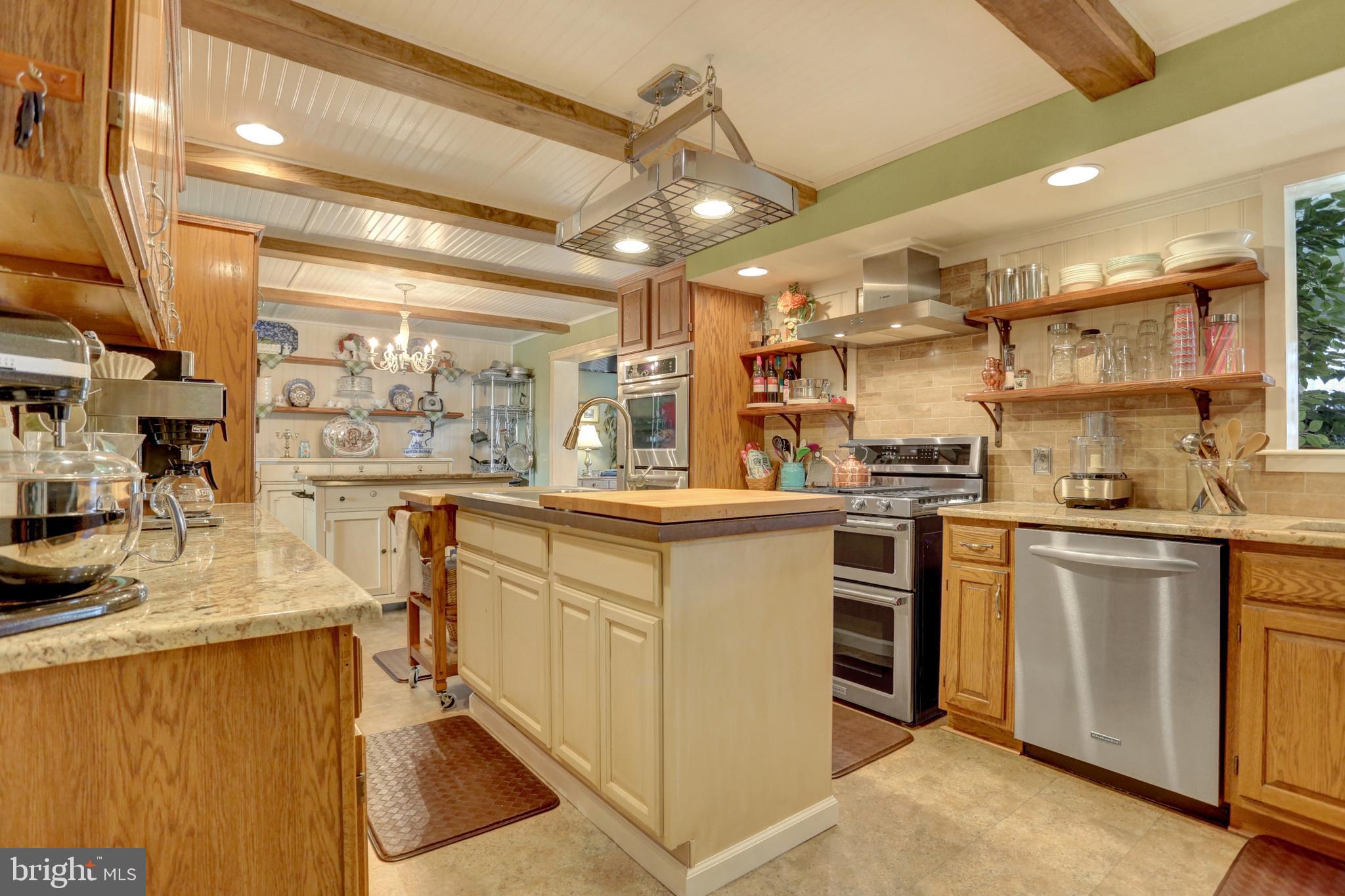 2301 Birch Road York, PA 17408 - Photo 13 of 40 a kitchen with kitchen island granite countertop a sink cabinets stainless steel appliances and a counter top space