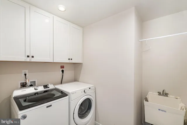 a view of storage and utility room with washer and dryer