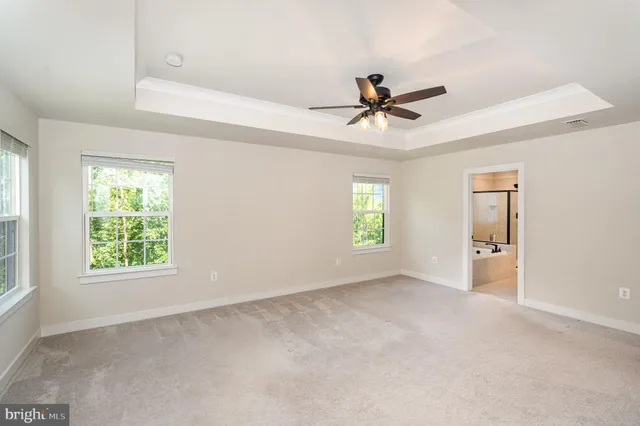 a view of room with a ceiling fan and window