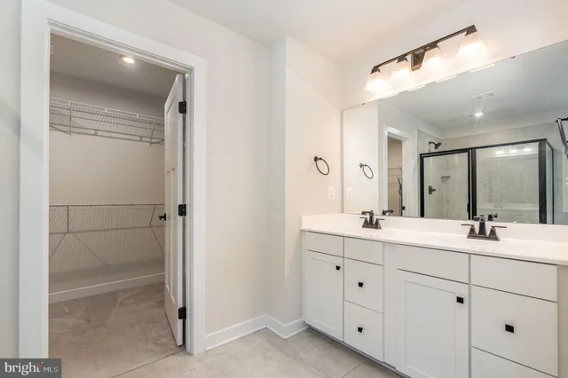 a bathroom with a double vanity sink and mirror