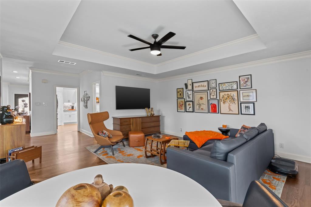 4304 Cobblers Lane Dallas, TX 75287 - Photo 12 of 31 a living room with furniture and a flat screen tv