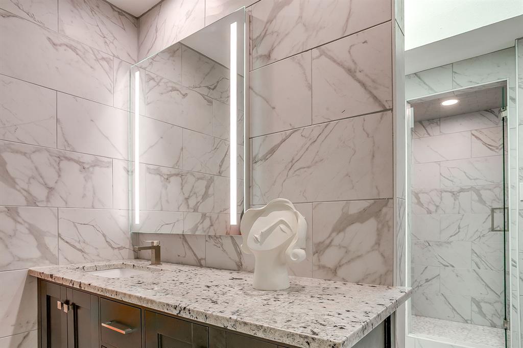 4304 Cobblers Lane Dallas, TX 75287 - Photo 17 of 31 a bathroom with a granite countertop sink and a mirror
