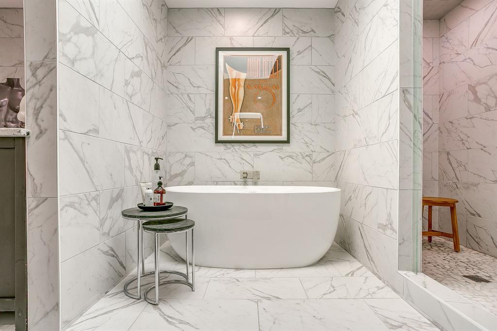 4304 Cobblers Lane Dallas, TX 75287 - Photo 18 of 31 a white bath tub sitting in a bathroom