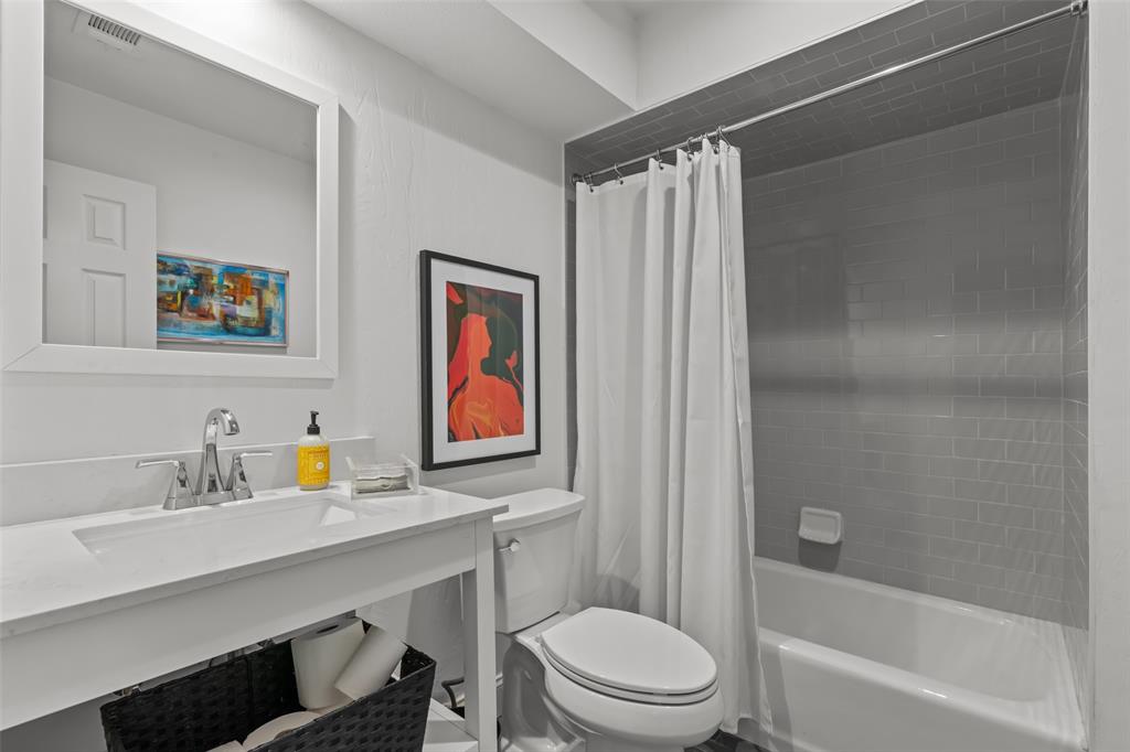 4304 Cobblers Lane Dallas, TX 75287 - Photo 20 of 31 a bathroom with a sink toilet and shower