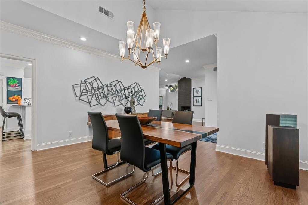 4304 Cobblers Lane Dallas, TX 75287 - Photo 2 of 31 a view of a dining room with furniture a chandelier and wooden floor