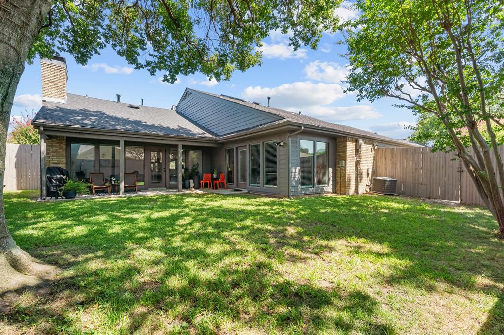4304 Cobblers Lane Dallas, TX 75287 - Photo 27 of 31 a view of a brick house with a big yard plants and large trees