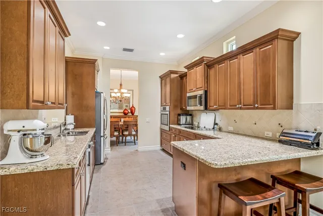 a dining room dining table chairs and a chandelier