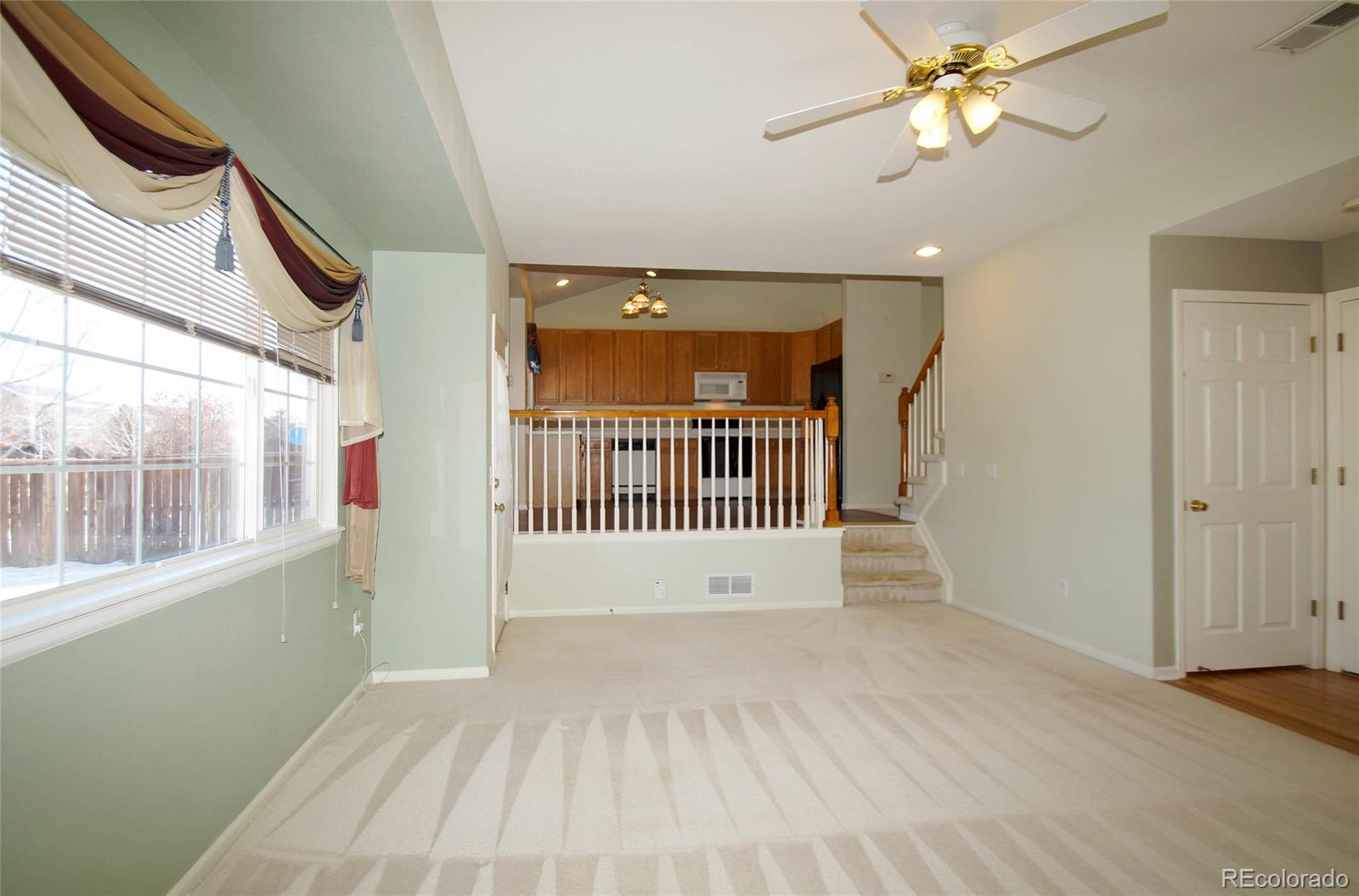9638 Silverberry Circle Highlands Ranch, CO 80129 - Photo 12 of 27 wooden floor in an empty room with a window