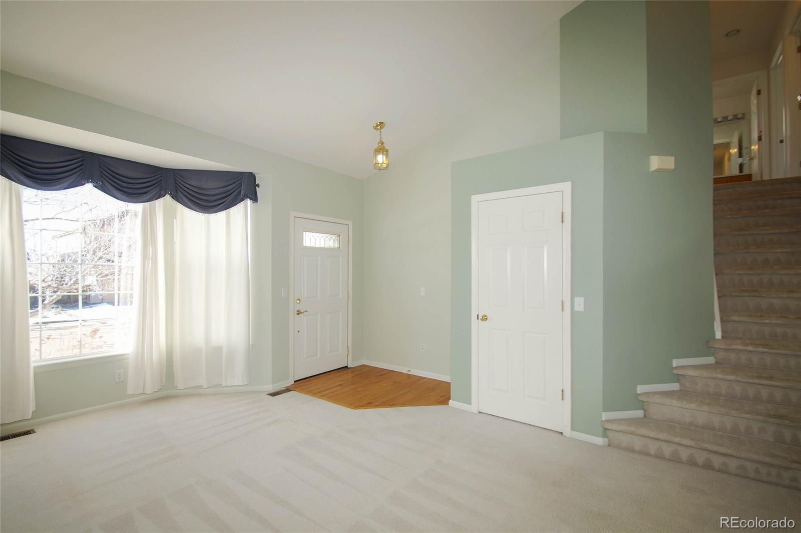 9638 Silverberry Circle Highlands Ranch, CO 80129 - Photo 13 of 27 a view of an empty room with a fireplace and a window