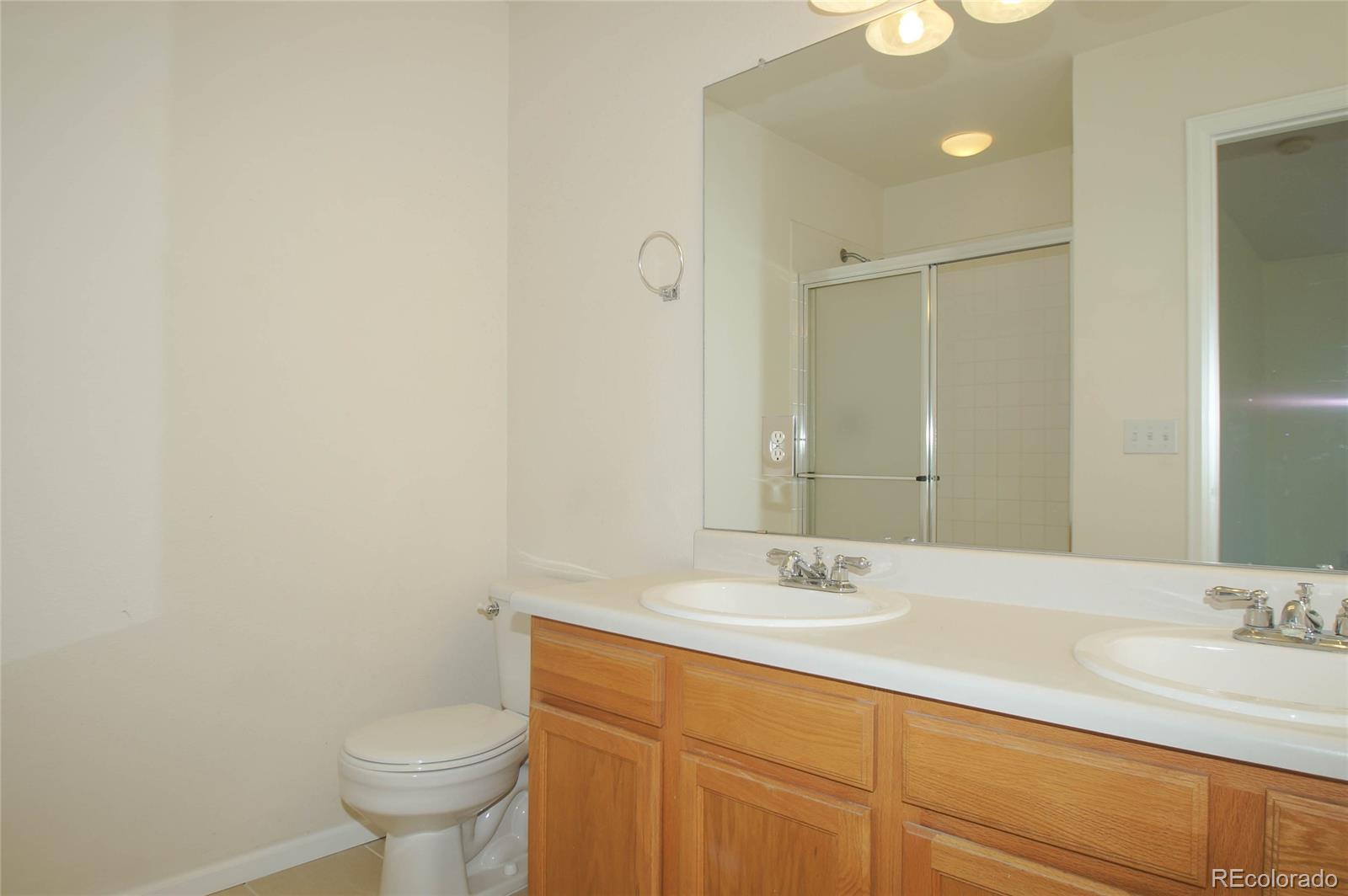 9638 Silverberry Circle Highlands Ranch, CO 80129 - Photo 17 of 27 a bathroom with a sink and a mirror