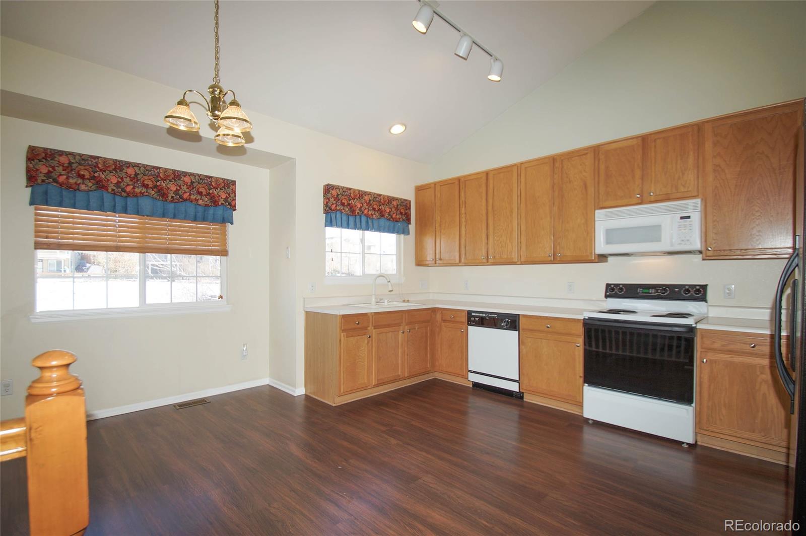 9638 Silverberry Circle Highlands Ranch, CO 80129 - Photo 2 of 27 a kitchen with stainless steel appliances granite countertop a sink a stove a refrigerator cabinets and wooden floor