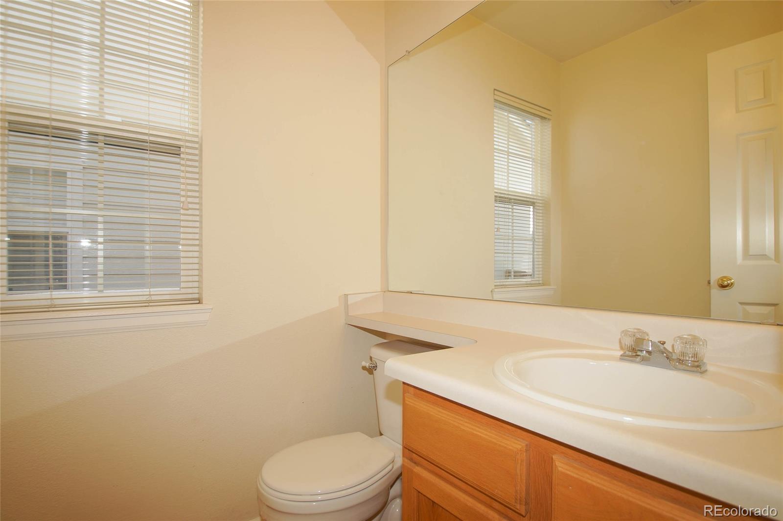 9638 Silverberry Circle Highlands Ranch, CO 80129 - Photo 23 of 27 a bathroom with a sink a toilet and tub