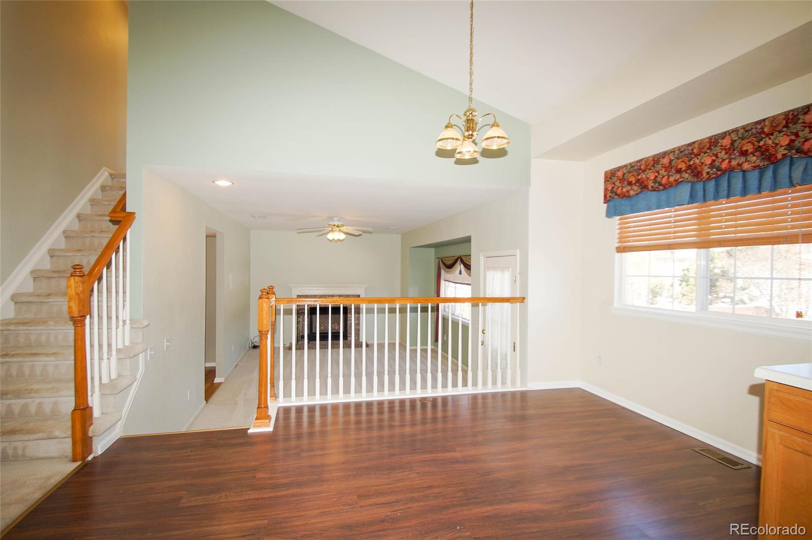 9638 Silverberry Circle Highlands Ranch, CO 80129 - Photo 4 of 27 a view of a livingroom with wooden floor and stairs