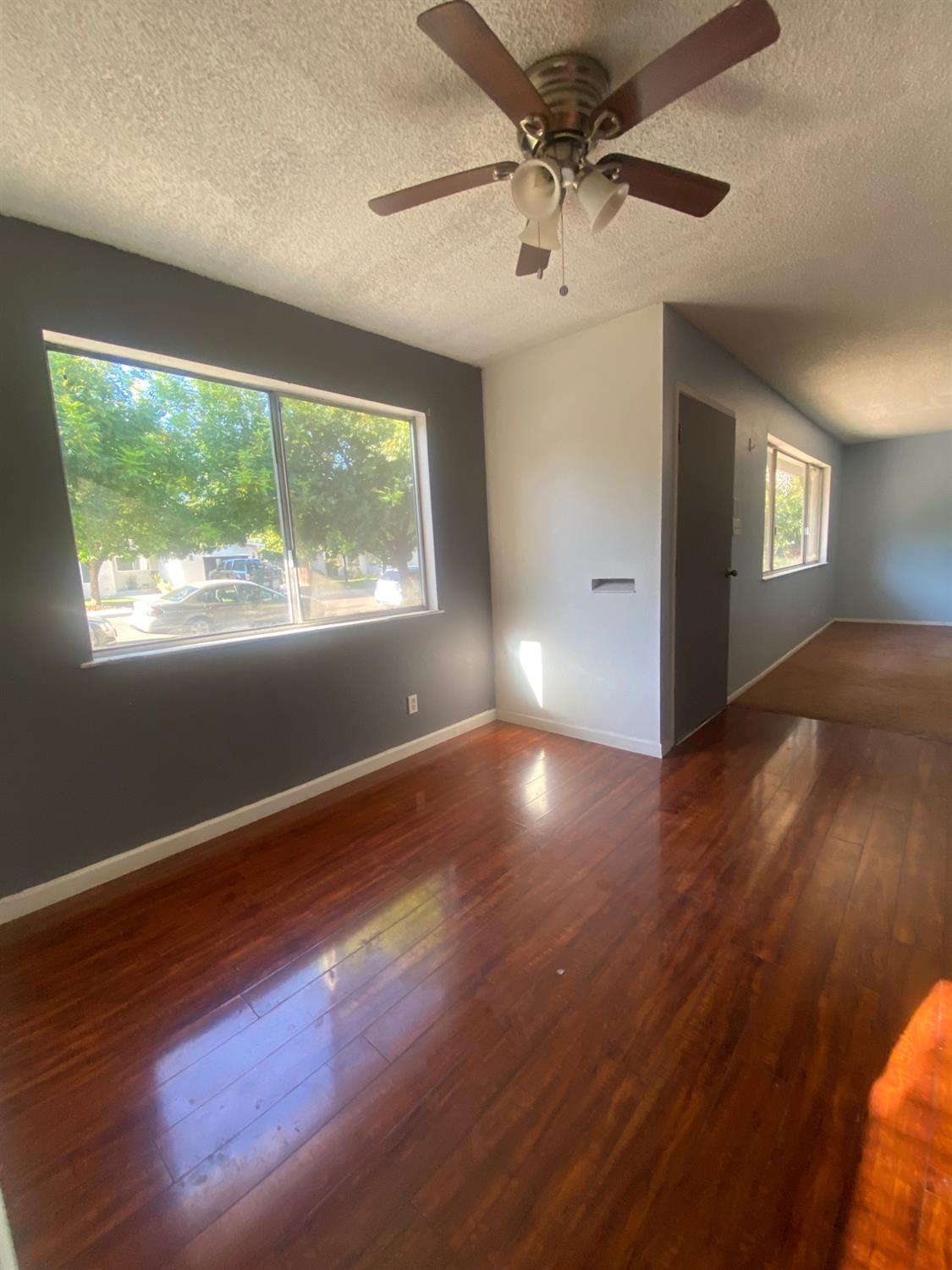 333 East Linden Avenue Reedley, CA 93654 - Photo 8 of 21 a view of an empty room with wooden floor and a window