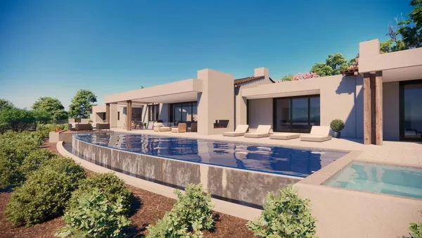 a view of a house with pool and chairs