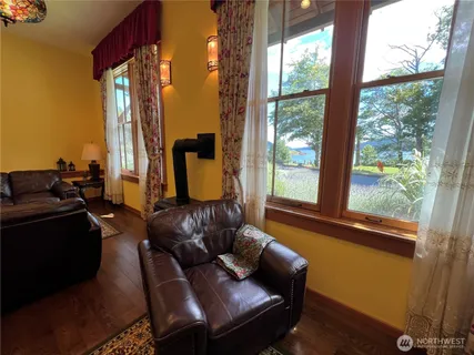 a living room with furniture and large windows