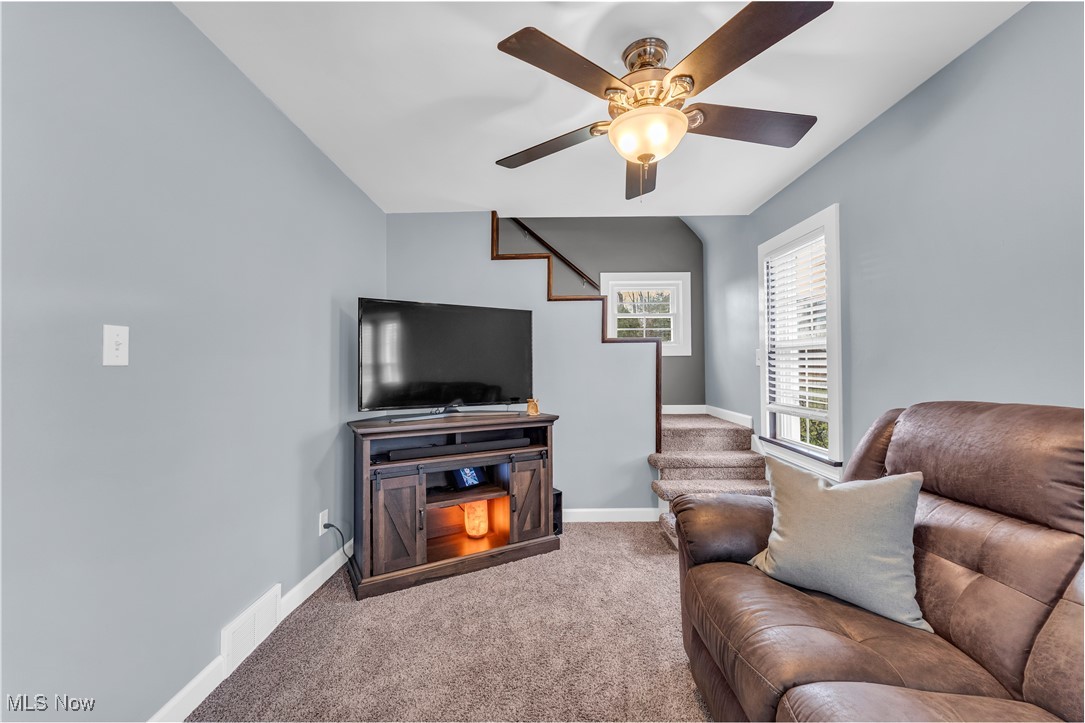7717 Wadsworth Road Medina, OH 44256 - Photo 12 of 43 Carpeted living room featuring baseboards and a ceiling fan