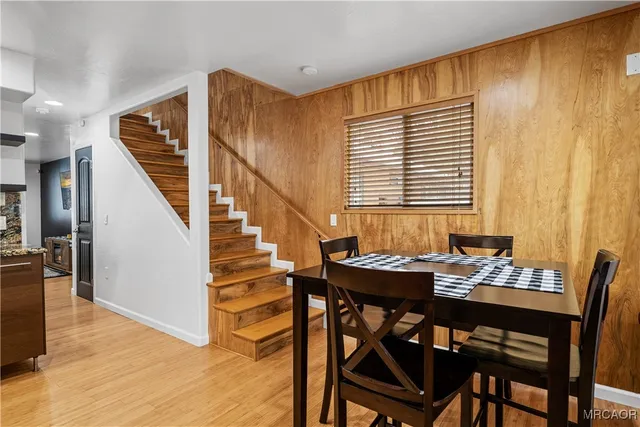a dining room with furniture and wooden floor