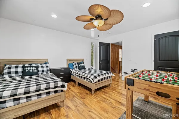 a bedroom with bed and a chandelier