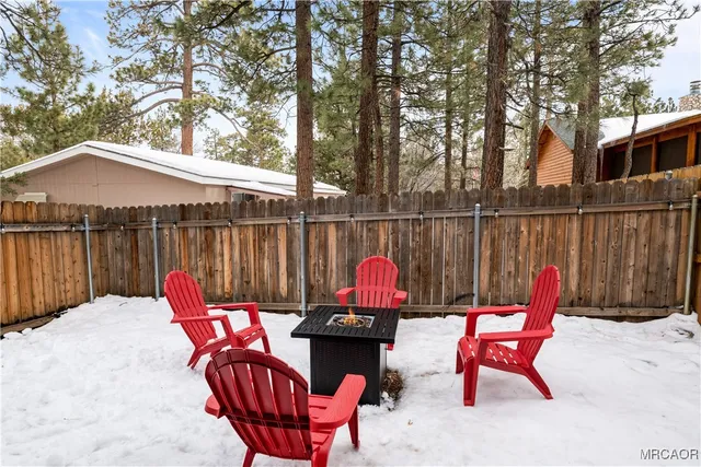 an outdoor sitting area with furniture and wooden floor