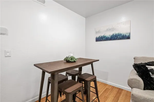 a view of a workspace with furniture and wooden floor