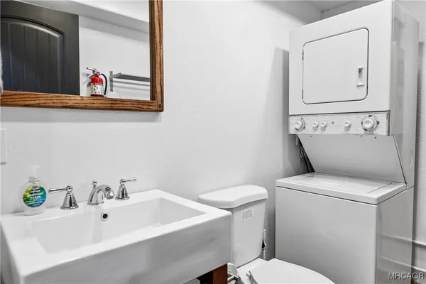 a white toilet sitting next to a bathroom sink