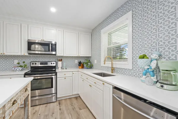 a kitchen with a counter space cabinets and appliances
