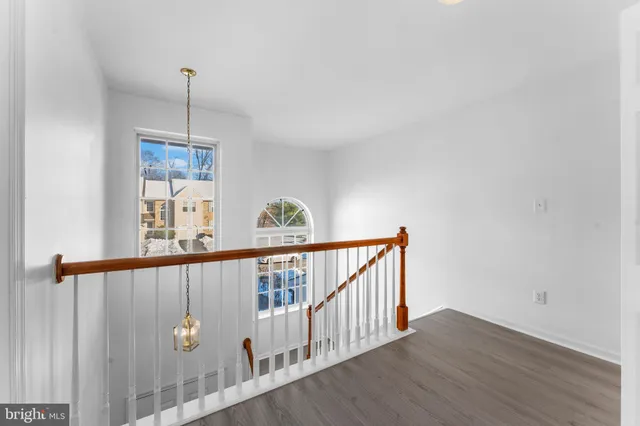a view of hallway with wooden floor