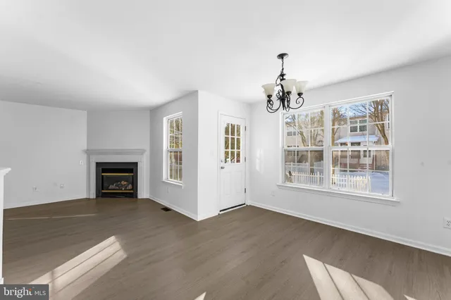 a view of livingroom with a fireplace wooden floor and windows