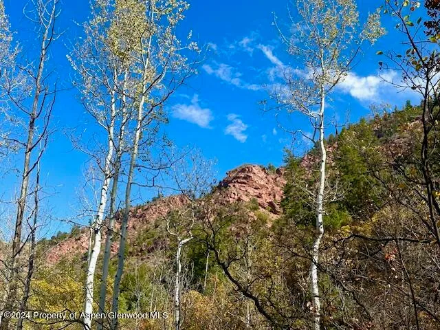 a view of a large mountain with mountains in the background
