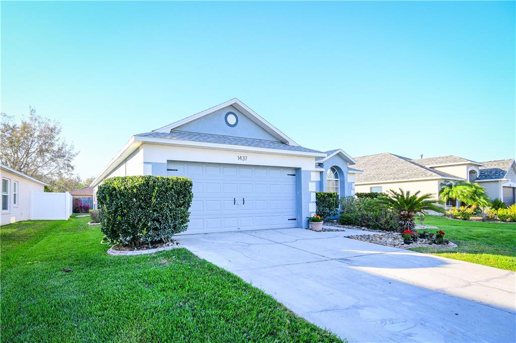 1437 Appleton Place Wesley Chapel, FL 33543 - Photo 1 of 1 a front view of a house with garden