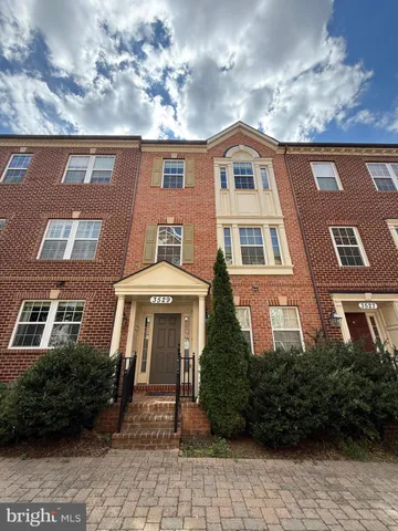a view of a brick building next to a yard
