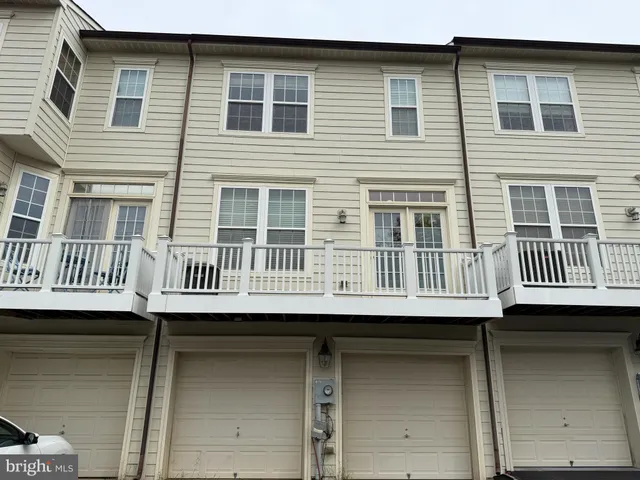 a view of a brick house with large windows