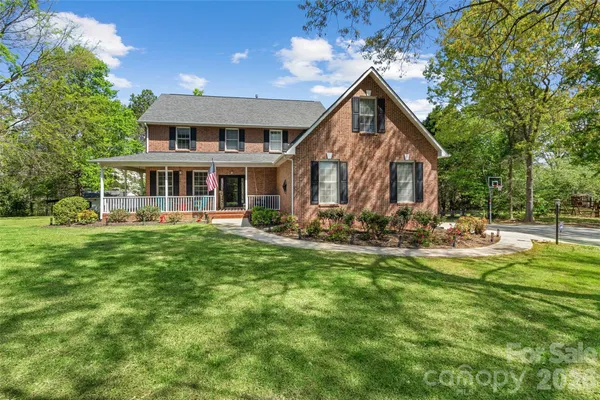 a view of a house with a yard patio and fire pit