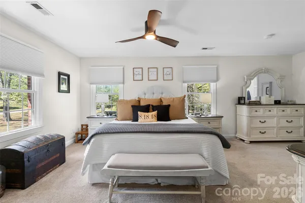 a bedroom with a bed a couch and dresser