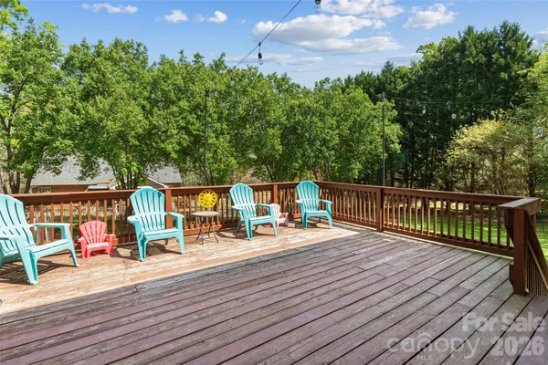 a view of a deck with furniture and garden