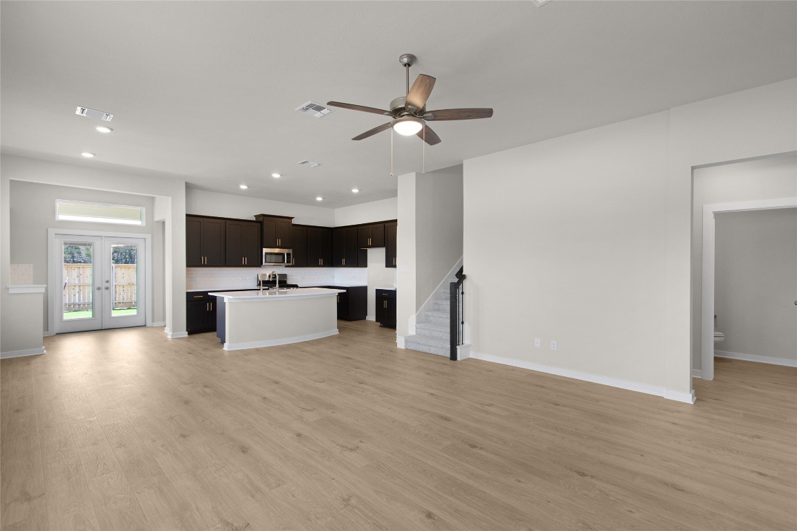 405 Raleigh Drive Georgetown, TX 78633 - Photo 23 of 36 a view of a kitchen with a sink cabinets and wooden floor