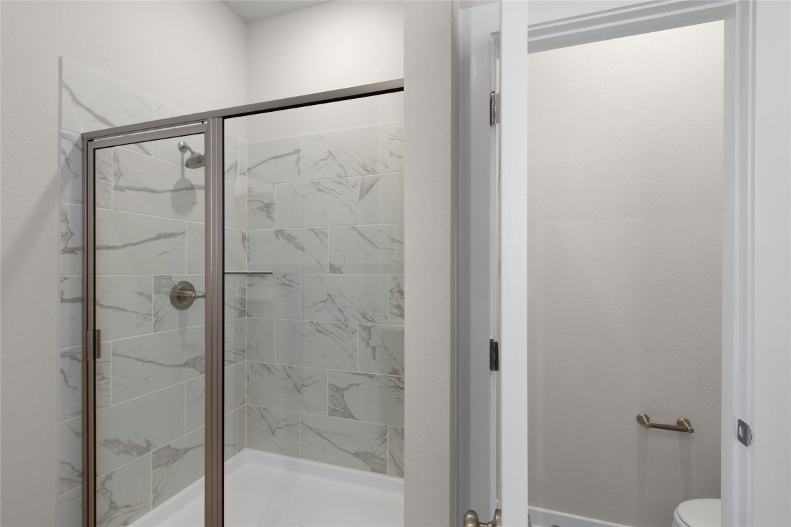 405 Raleigh Drive Georgetown, TX 78633 - Photo 29 of 36 a bathroom with a glass shower door
