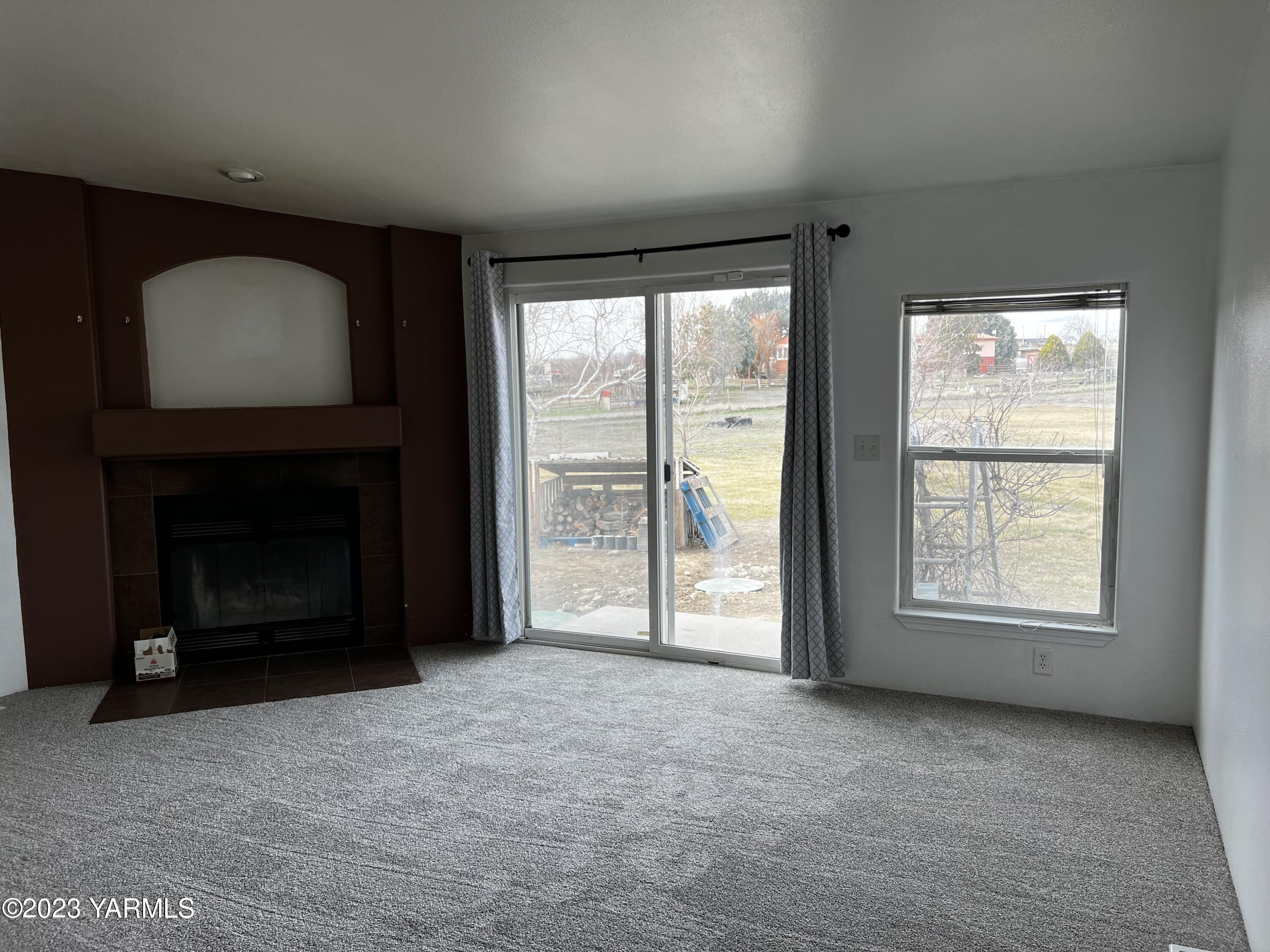 12102 North Hinzerling Road Prosser, WA 99350 - Photo 11 of 43 an empty room with windows and fireplace