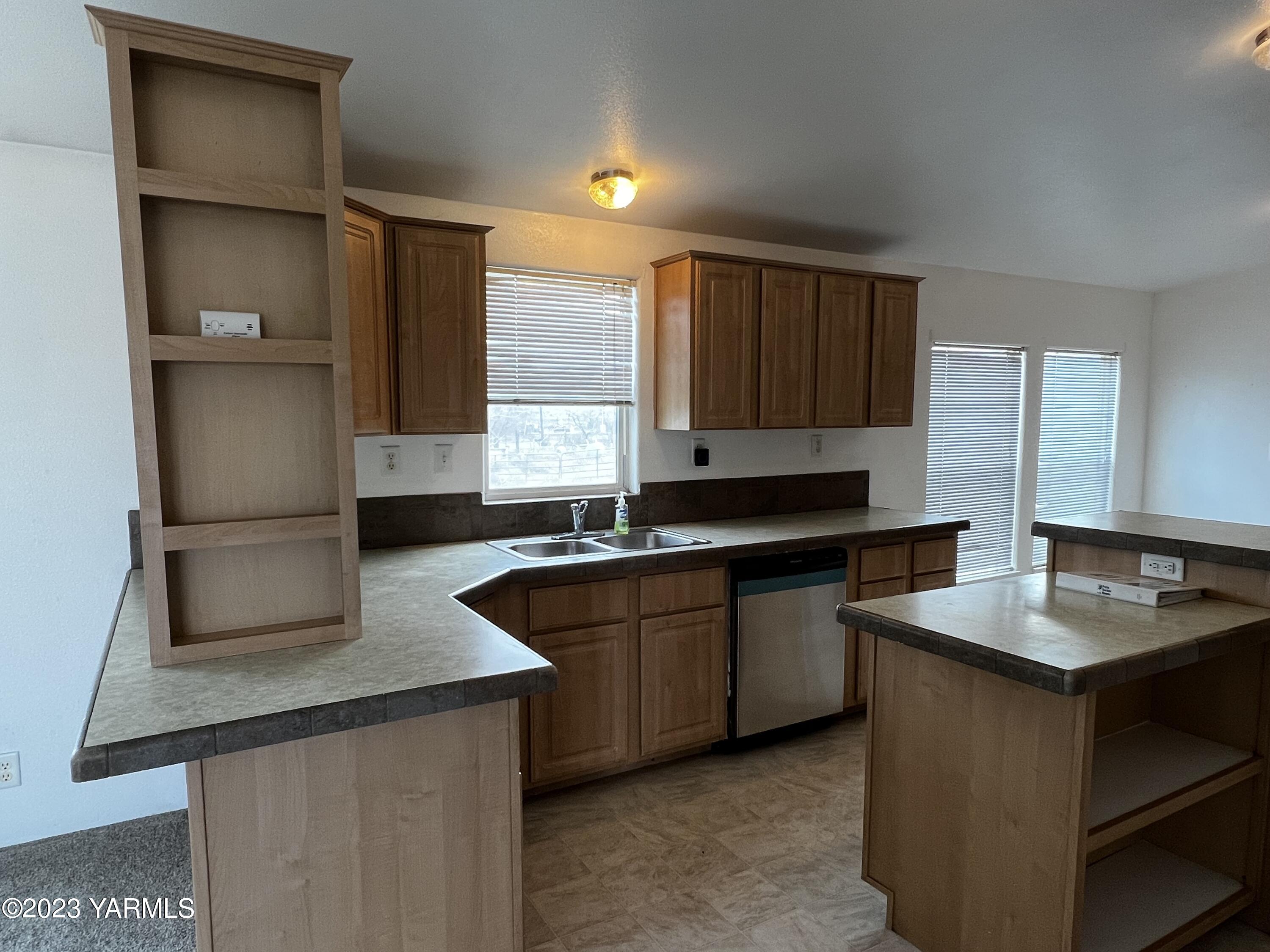 12102 North Hinzerling Road Prosser, WA 99350 - Photo 17 of 43 a kitchen with granite countertop a sink and a refrigerator