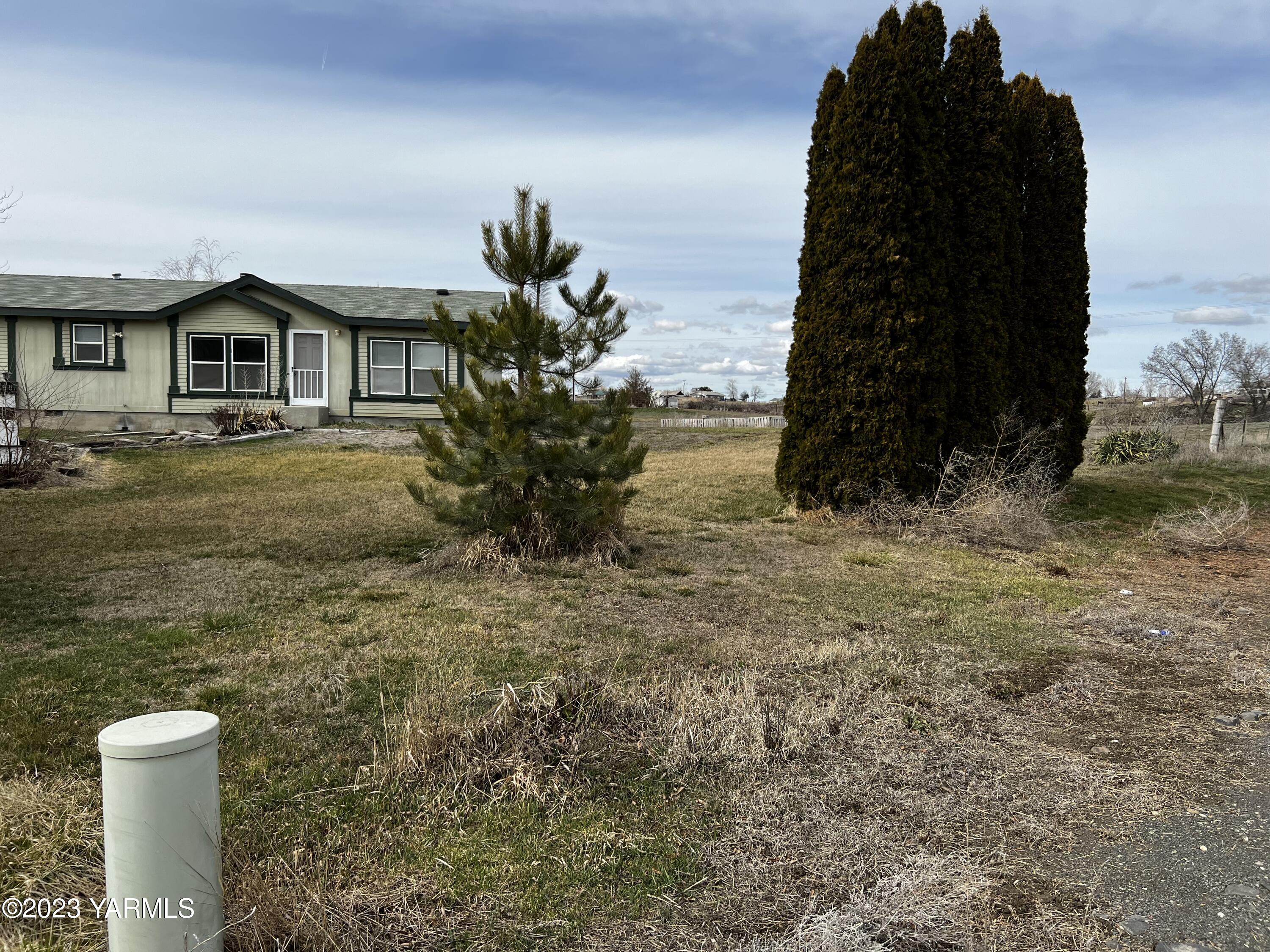 12102 North Hinzerling Road Prosser, WA 99350 - Photo 2 of 43 a front view of a house with a yard