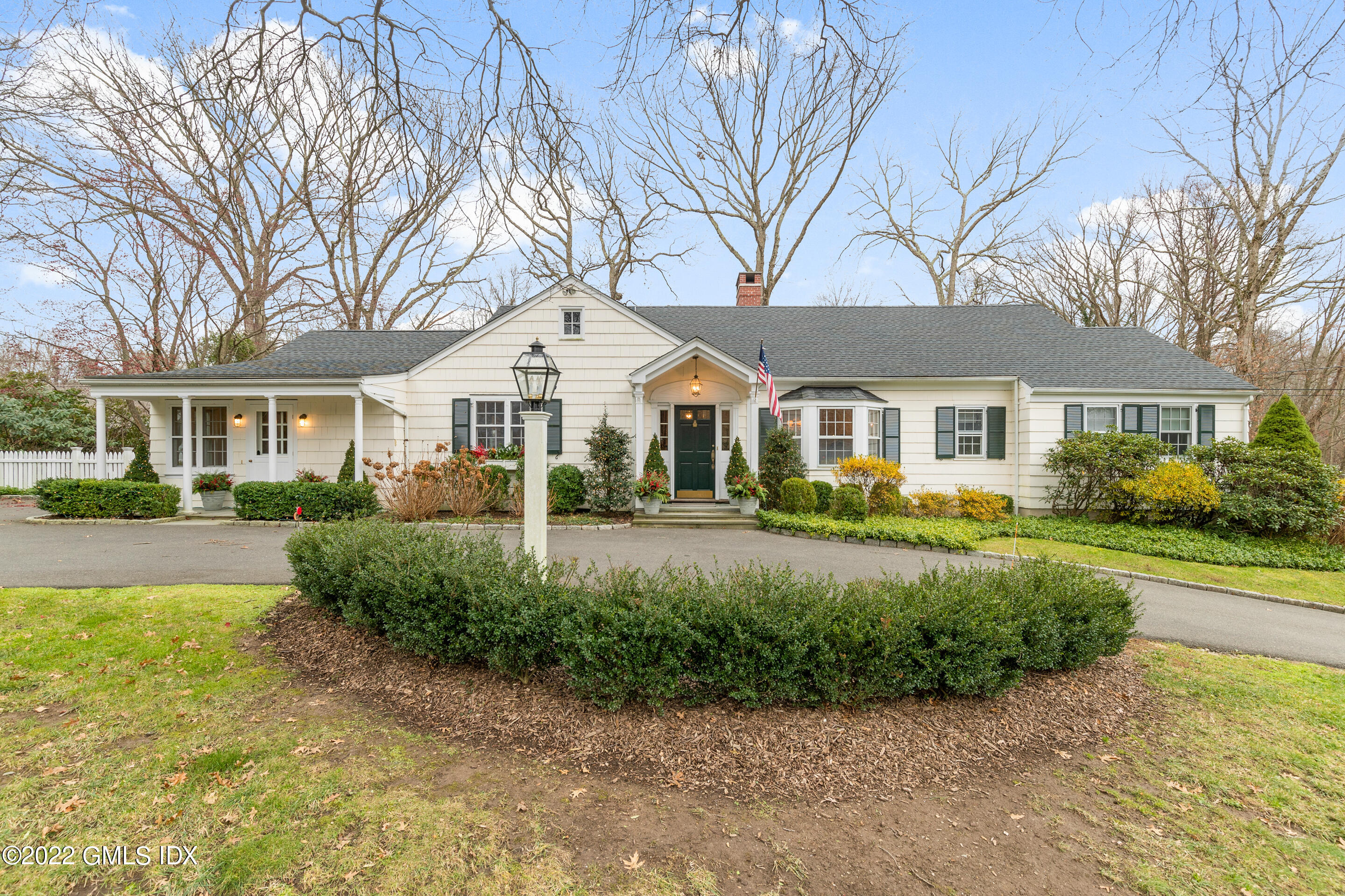 a front view of a house with a yard and porch