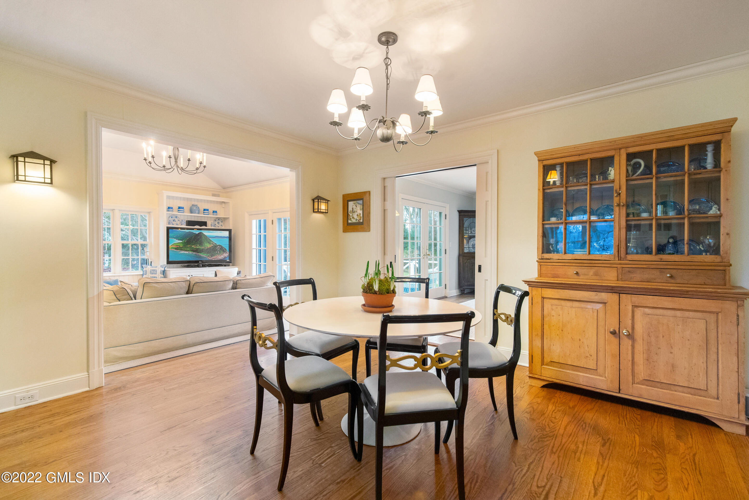32 Alpine Road Greenwich, CT 06830 - Photo 8 of 17 a dining room with wooden floor a chandelier a wooden table and chairs