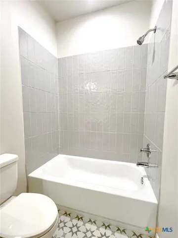 a white bath tub sitting in a bathroom