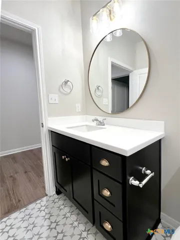 a bathroom with a toilet a sink and mirror