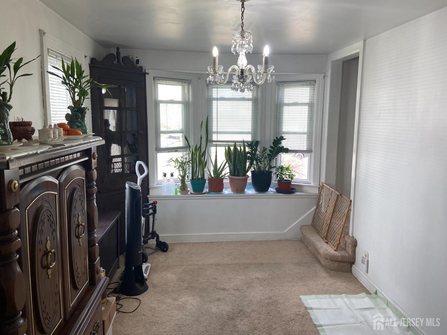739 Ridgedale Avenue Woodbridge, NJ 07095 - Photo 4 of 10 a view of a living room with entryway and chandelier