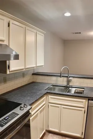 a kitchen with a sink and cabinets