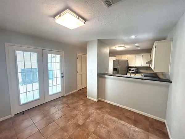 a view of kitchen with stainless steel appliances granite countertop a refrigerator sink and cabinets