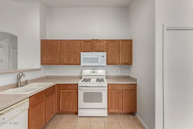 a kitchen with a stove top oven sink and cabinets